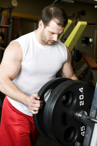 adding plates to a barbell