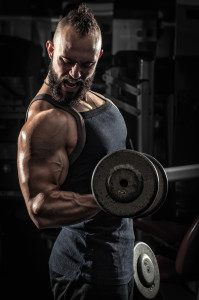 Muscular Man Lifting Some Heavy Dumbells