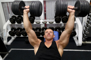 strong man lifting barbell in gym